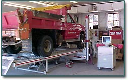 Town truck on lift in body shop